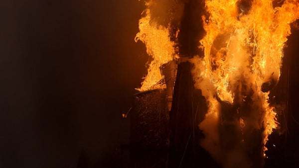 A picture of a large orange set of flames in a dark building. Used to support information about ASTM F1959 - Standard Test Method for Determining the Arc Rating of Materials for Clothing