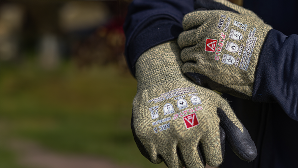 A close up of a pair of grey Skanwear safety gloves